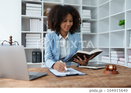 A young women African American lawyer lawsuit studying cases for clients in a law firm to fight against their parties in the courts. law and attorney concepts 104915640