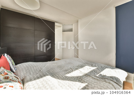 a bedroom with blue walls and white bed in the fore - image viatio com / photo viatio 104916364