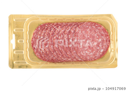 Servelat sausage sliced on a plastic substrate over a white background. 104917069