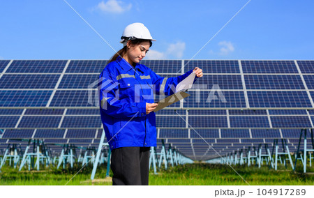 Engineer worker portrait with solar panel at solar farm Engineer worker portrait with solar panel at solar farm 104917289