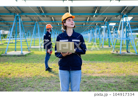 Workers installing solar panels, Engineer team at solar panel farm Workers installing solar panels, Engineer team at solar panel farm 104917334
