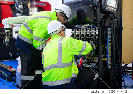 Electrician working with terminal power cable and controlled equipment 104917489