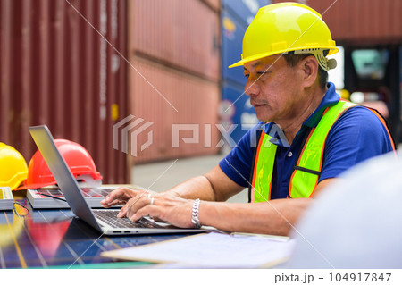 Warehouse engineer worker working at industrial container yard 104917847