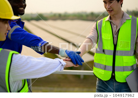 Engineers checking solar panels on solar power plant 104917962