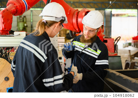 Mechanical engineers repairing engine machine at factory 104918062