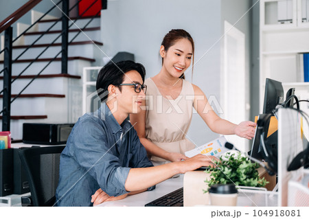 Couple of business people working together at modern office 104918081