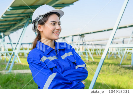Engineer worker portrait with solar panels at solar farm 104918331