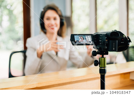 Professional businesswoman with wireless headphones meeting and having conversation with partners clients online, Call center agent with headsets working on support hotline in modern office 104918347
