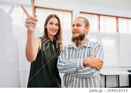 Couple of professional business people meeting and briefing together 104918353