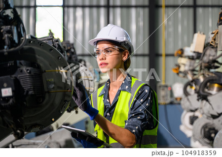 Female business owner engineer managing and checking work at factory 104918359