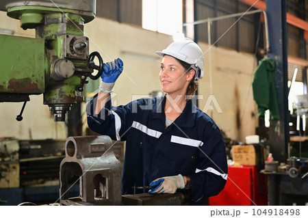 Mechanical engineer repairing engine machine at factory Mechanical engineer repairing engine machine at factory 104918498