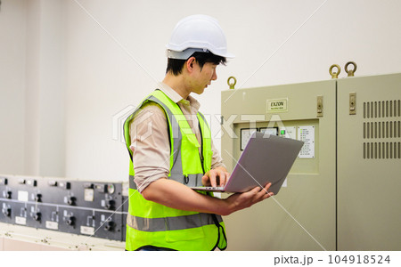 Happy maintenance engineer checking and maintaining solar panels Happy maintenance engineer checking and maintaining solar panels 104918524