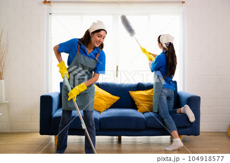 Couple of housekeeping staff cleaning house, Housekeeping and cleaning service, People doing housework at home Couple of housekeeping staff cleaning house, Housekeeping and cleaning service, People doing housework at home 104918577