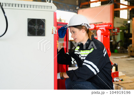 Mechanical engineer repairing engine machine at factory 104919196