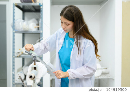 Technician making prosthetic device using grinder to smooth socket 104919500