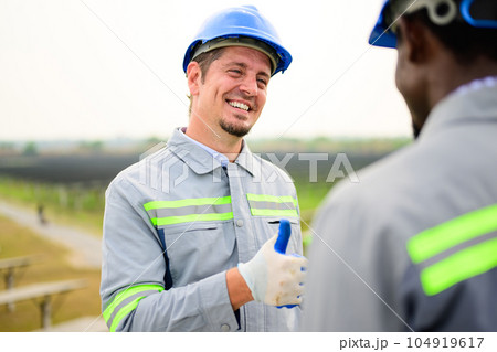 Happy maintenance engineers checking and maintaining solar panels Happy maintenance engineers checking and maintaining solar panels 104919617