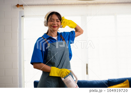 Happy woman cleaning house, Housekeeping and cleaning service, People doing housework at home 104919720