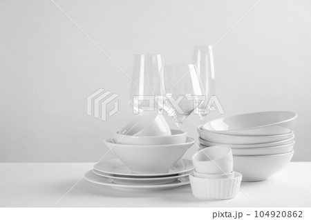 Set of clean dishes on white table 104920862
