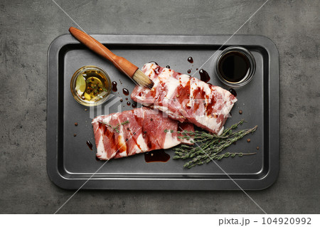 Fresh raw ribs on grey table, top view Fresh raw ribs on grey table, top view 104920992