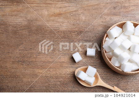 Refined sugar on wooden table, flat lay. Space for text 104921014