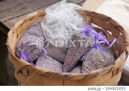 Pouch with lavender in a wooden basket.  104922055