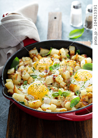 Potato hash with ham and eggs 104923391