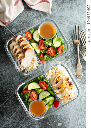 Meal prep containers with grilled chicken 104923402