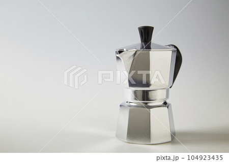 Typical Italian coffee pot or moka in aluminum on white Typical Italian coffee pot or moka in aluminum on white 104923435
