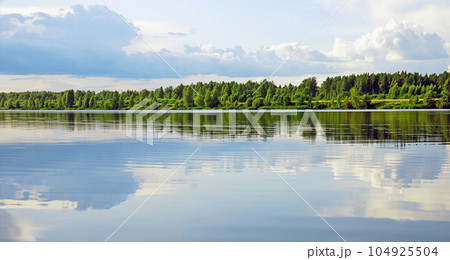 river landscape with blue cloudy sky and green forest 104925504