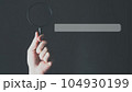Search Engine Optimization, Search bar on virtual screen with hand holding magnifying glass. 104930199