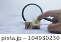 Financial concept to analysing business progress with magnifying glass on background. 104930230