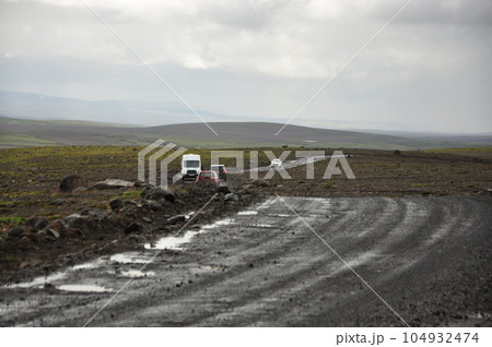 Motorhomes on a gravel road in Iceland on a cloudy day 104932474