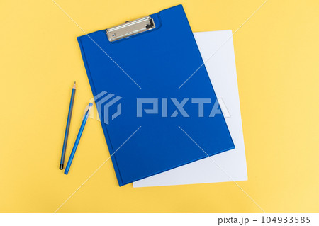 A set of blue stationery as a template with a place to copy on a yellow background, pen and pencil A set of blue stationery as a template with a place to copy on a yellow background, pen and pencil 104933585