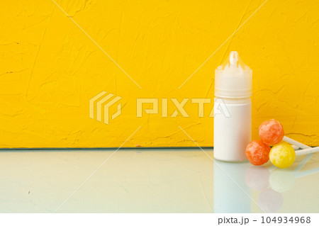 Bottle with aromatic vaping liquid for e-cigarette, candy flavour Bottle with aromatic vaping liquid for e-cigarette, candy flavour 104934968
