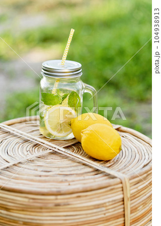 Plate with ripe fresh lemons and lemonade sassy water. Vitamins concept. copy space. Strengthening immunity concept. Tropical fruit. Organic citrus fruits for a healthy diet. 104938913