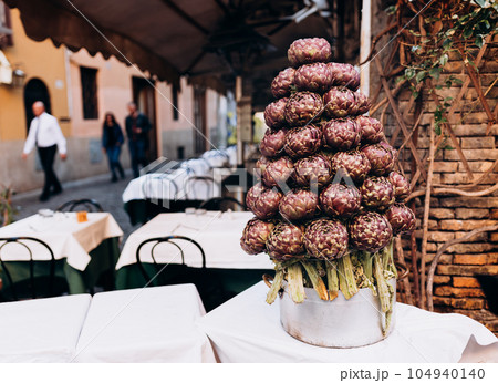 Bouquet of artichokes in a bucket on the table. Some Roman artichokes exposed like flowers. A heap of beautiful fresh Romanesco artichokes Bouquet of artichokes in a bucket on the table. Some Roman artichokes exposed like flowers. A heap of beautiful fresh Romanesco artichokes 104940140