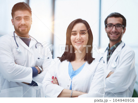 Three medical colleagues stand in the lobby of the hospital Three medical colleagues stand in the lobby of the hospital 104940916