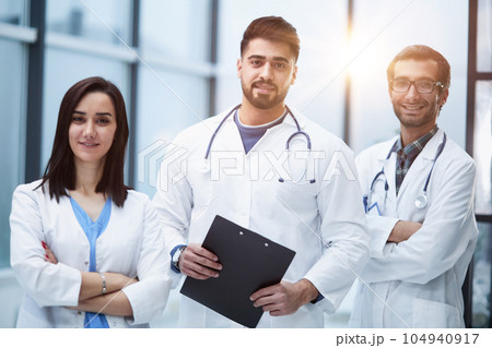 Portrait of three confident doctors in the hospital corridor Portrait of three confident doctors in the hospital corridor 104940917