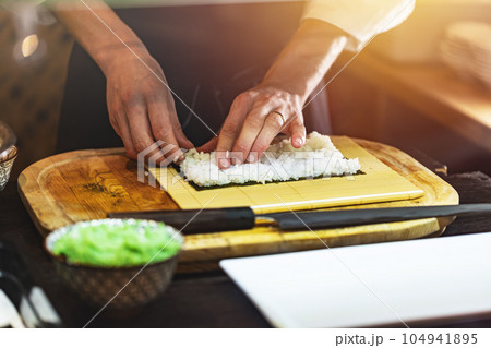 Chef making Japanese sushi rolls. Chef making Japanese sushi rolls. 104941895
