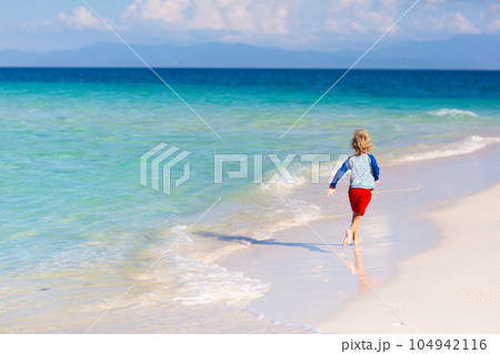 Kids playing on beach. Children play at sea. 104942116
