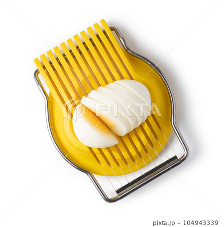 Boiled egg in the egg slicer. 104943339