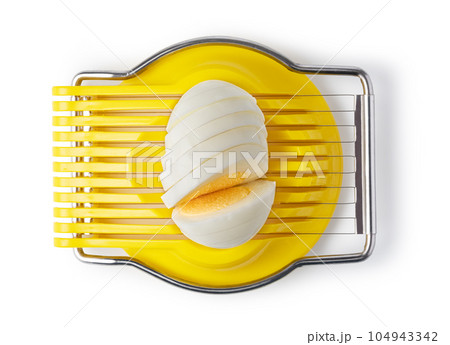 Boiled egg in the egg slicer. 104943342