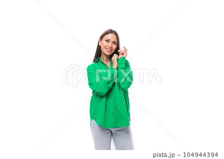 confident slim european brunette woman model with long hair and brown eyes dressed in casual green 104944394