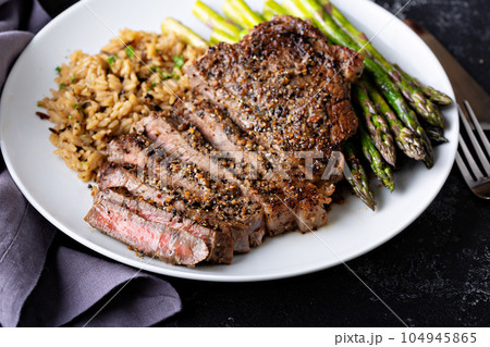 Delisious steak with rice and asparagus Delisious steak with rice and asparagus 104945865