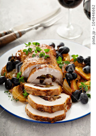 Roasted pork loin stuffed with apple and cranberry 104946662