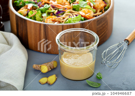 Ginger peanut asian salad dressing 104946687