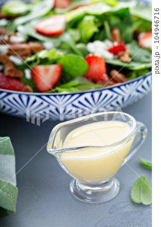 Italian dressing in a small sauce dish Italian dressing in a small sauce dish 104946716