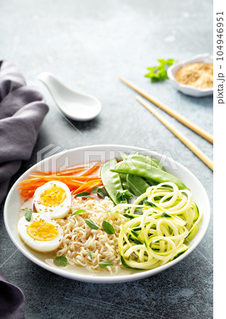 Bowl of noodles with egg and vegetables 104946951
