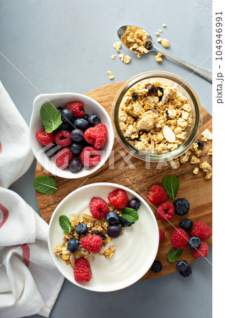 Plain yougurt with granola on side Plain yougurt with granola on side 104946991