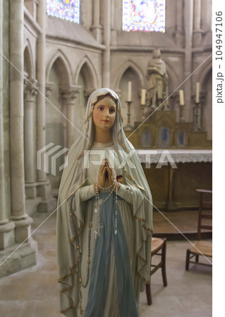 A statue of the Virgin Mary who praying 104947106